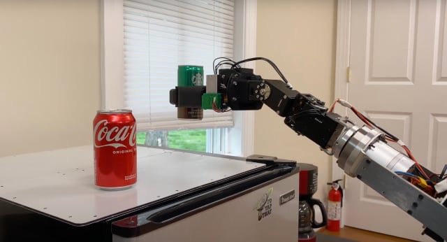 Model R2 robotic manipulator arm picking up a can of coffee from the top of a mini refrigerator