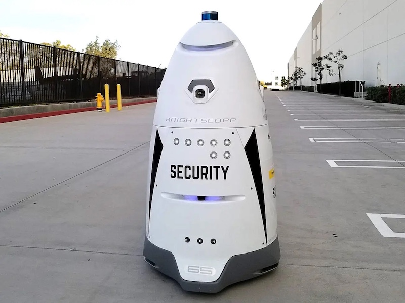 An Autonomous Mobile Robot (AMR) for security and surveillance patrols a parking lot of a large store.