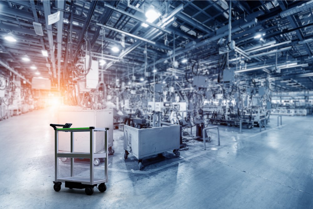 Model C2 Autonomous Mobile Robot (AMR) in a large manufacturing plant surrounded by production equipment