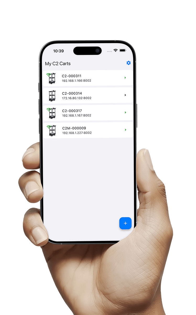 User holding mobile phone with C2 Remote app, displaying their list of Registered Model C2 Carts for autonomous material delivery