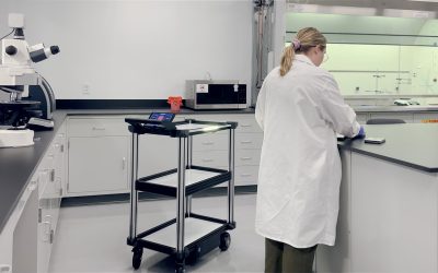 Model C2 workplace robot carrying parts between stations while an operator stays at a machine